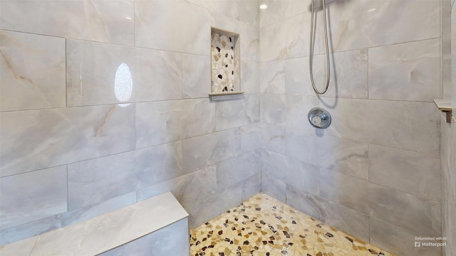 bathroom with a tile shower