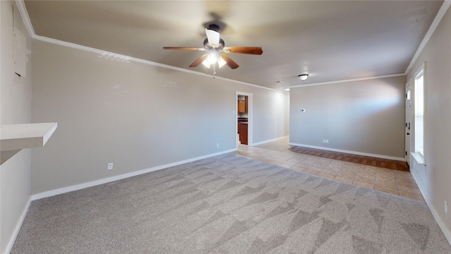 spare room with light tile patterned floors, ornamental molding, and ceiling fan