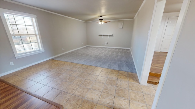 tiled spare room featuring ceiling fan and ornamental molding