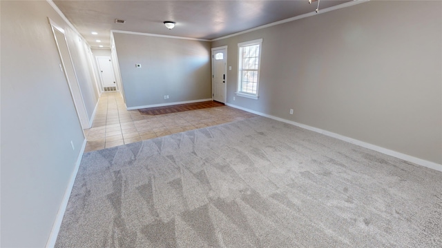 tiled spare room featuring ornamental molding