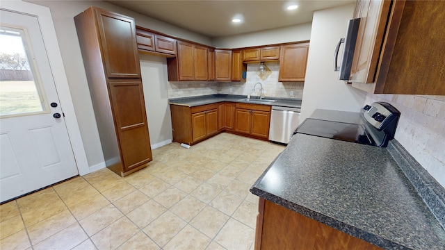 kitchen with stainless steel appliances, tasteful backsplash, and sink