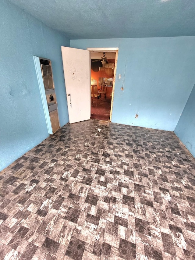 1308 Harrington Ave, Fort Worth, TX 76164 - unfurnished room featuring a textured wall and a textured ceiling