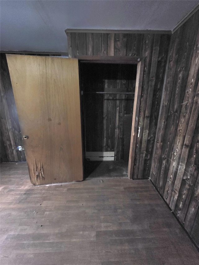 1308 Harrington Ave, Fort Worth, TX 76164 - unfurnished bedroom with wood finished floors and wood walls