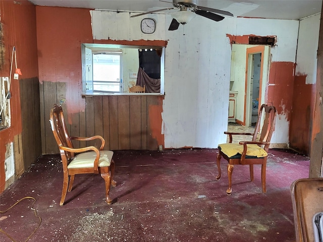 1308 Harrington Ave, Fort Worth, TX 76164 - sitting room with ceiling fan, concrete floors, and wood walls
