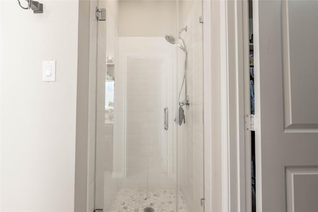 bathroom with a shower with door