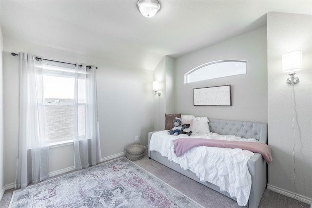 carpeted bedroom with vaulted ceiling and multiple windows