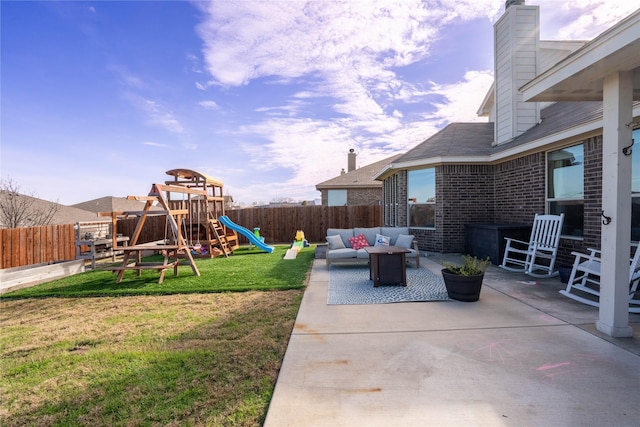 view of yard with an outdoor living space, a patio area, and a playground