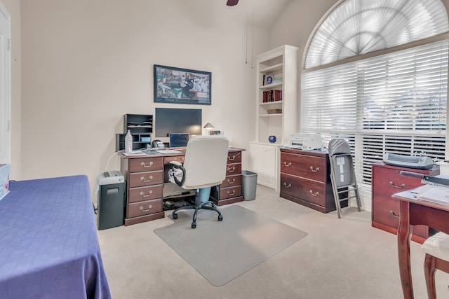 office space featuring light carpet and lofted ceiling