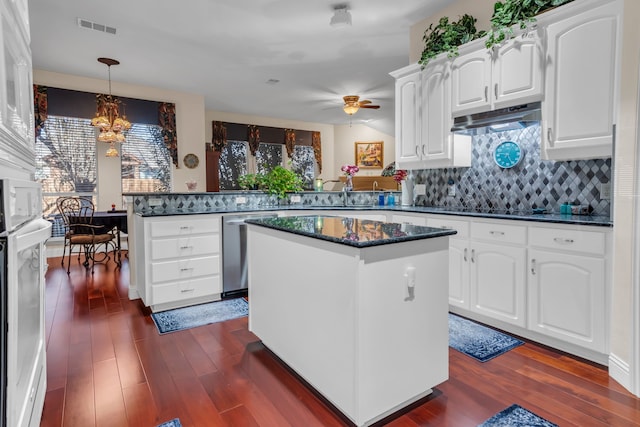 kitchen with pendant lighting, white cabinets, a center island, dishwasher, and kitchen peninsula