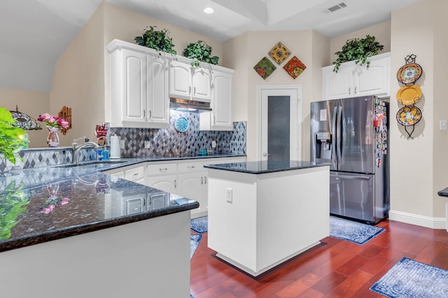 kitchen featuring backsplash, white cabinetry, stainless steel fridge with ice dispenser, and a center island