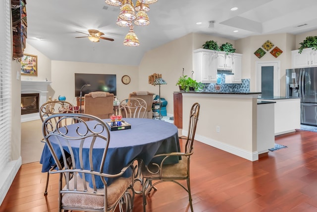 dining area with dark wood-type flooring and ceiling fan