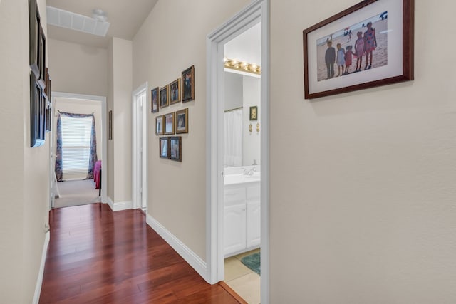 hall with dark hardwood / wood-style flooring and sink