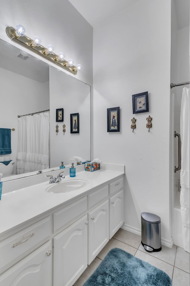 bathroom with shower / bath combo with shower curtain, tile patterned floors, and vanity