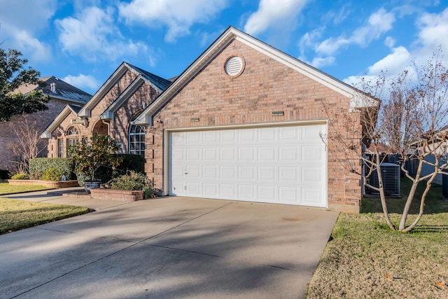 view of front of house featuring a garage and central AC unit