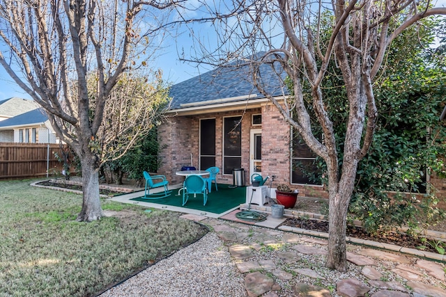 exterior space featuring a patio area and a yard