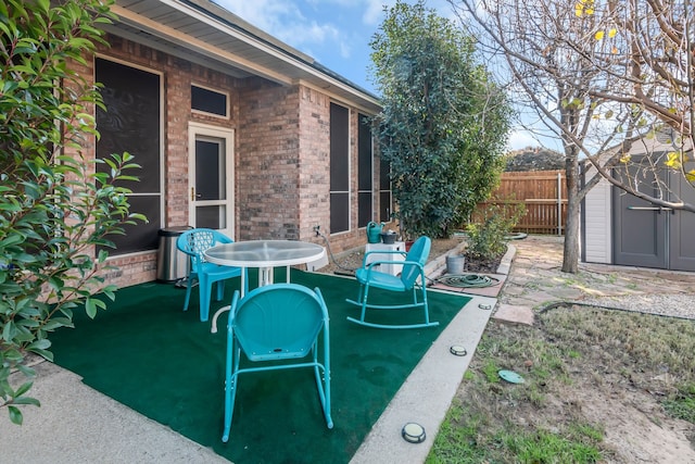 view of patio / terrace featuring a storage unit