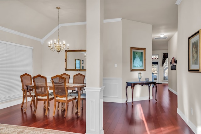 dining area with lofted ceiling, a notable chandelier, crown molding, and ornate columns