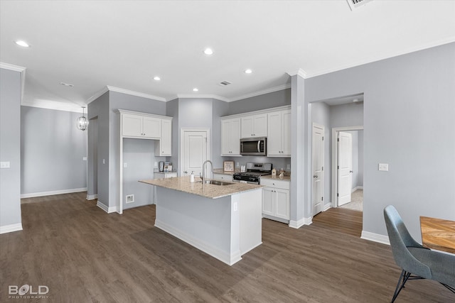 kitchen featuring baseboards, an island with sink, appliances with stainless steel finishes, dark wood-style floors, and white cabinets