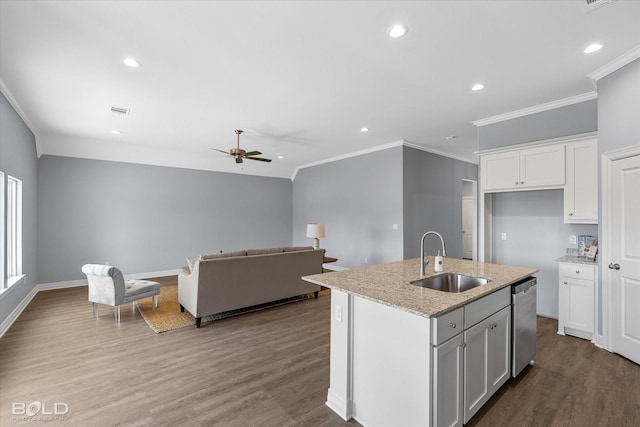 kitchen with a sink, ceiling fan, wood finished floors, white cabinets, and stainless steel dishwasher