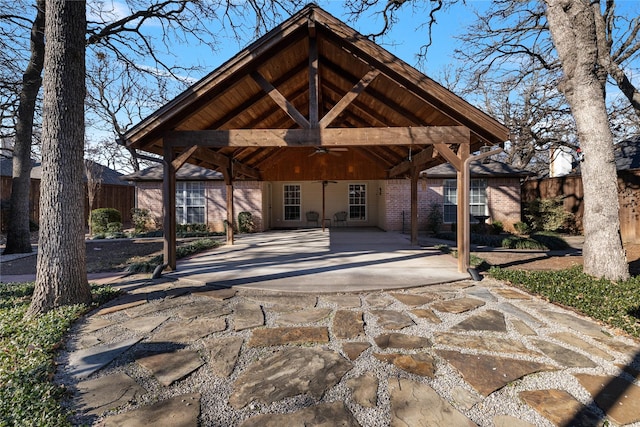 705 Parkridge Blvd, Burleson, TX 76028 - back of property featuring a ceiling fan, fence, driveway, and brick siding