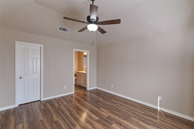 unfurnished bedroom featuring ceiling fan, dark wood-type flooring, connected bathroom, and lofted ceiling