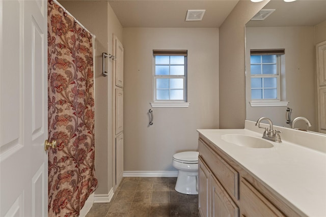 bathroom with toilet and vanity