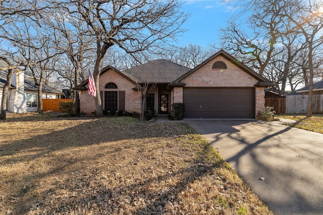 705 Parkridge Blvd, Burleson, TX 76028 - view of front facade with brick siding, an attached garage, fence, driveway, and a shingled roof