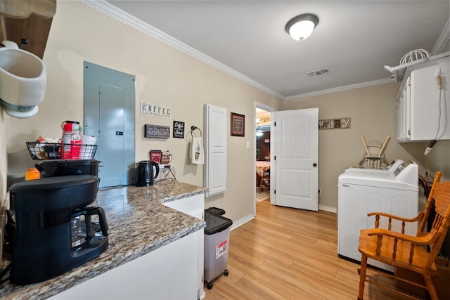 interior space with visible vents, white cabinets, independent washer and dryer, electric panel, and light wood finished floors