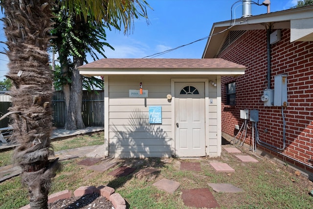 exterior space featuring fence and brick siding