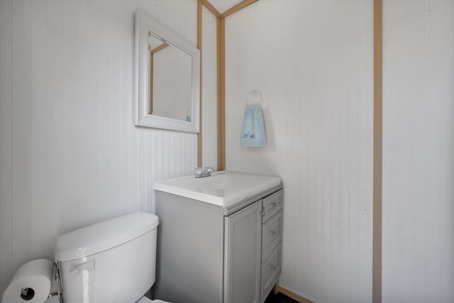 half bathroom with toilet and vanity