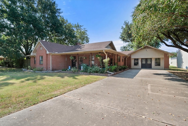 ranch-style house with brick siding, driveway, and a front lawn