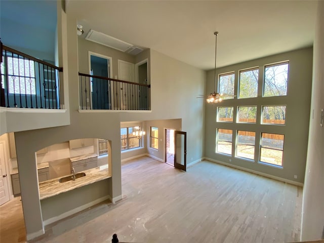 living room with ceiling fan with notable chandelier and light wood-type flooring