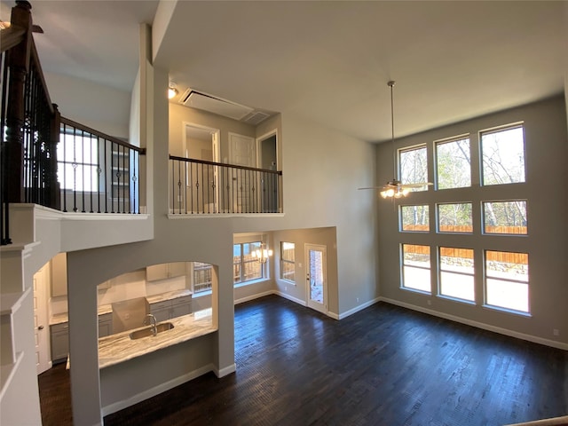 living area with plenty of natural light, dark wood finished floors, and baseboards