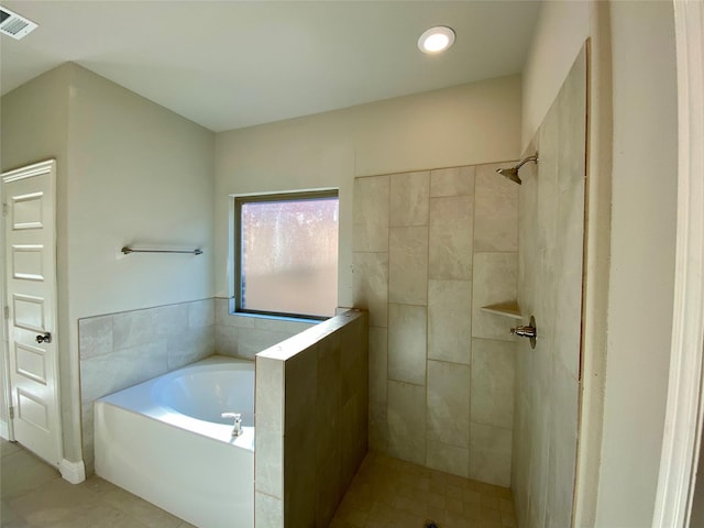 bathroom with tile patterned flooring and independent shower and bath