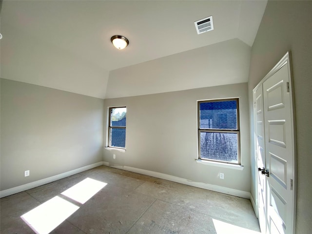 unfurnished room with lofted ceiling