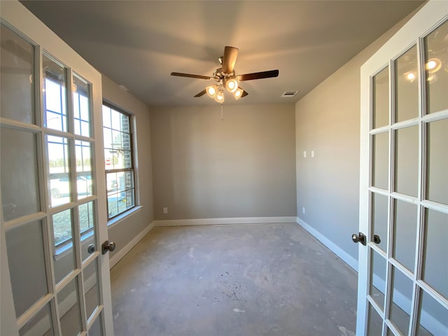 empty room featuring ceiling fan and a wealth of natural light