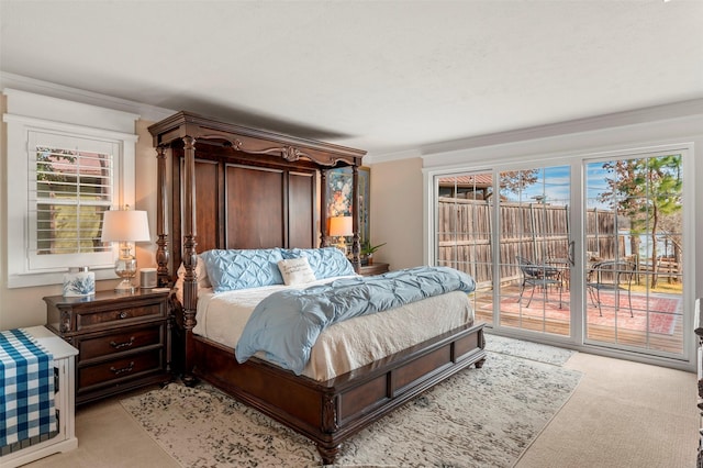 carpeted bedroom featuring crown molding and access to outside