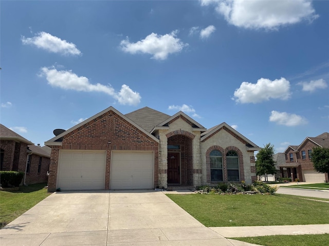 view of front of property featuring a front yard and a garage