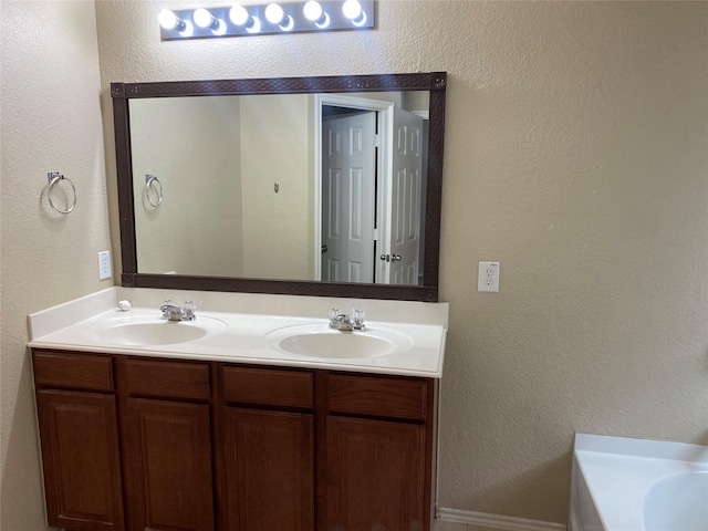 bathroom featuring vanity and a tub