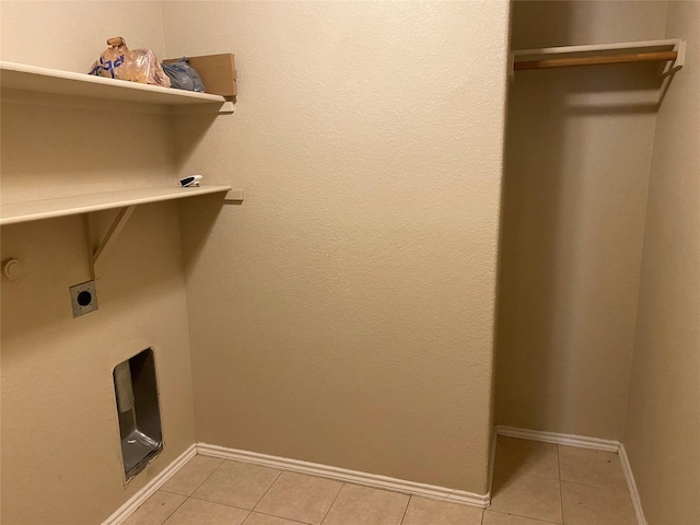 clothes washing area featuring light tile patterned floors and electric dryer hookup