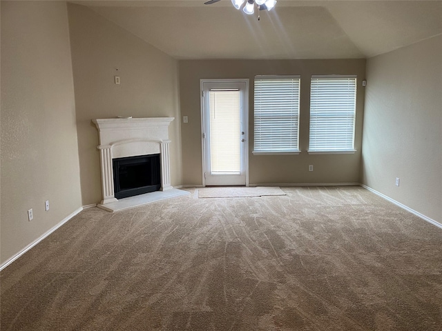 unfurnished living room with ceiling fan, light carpet, and vaulted ceiling