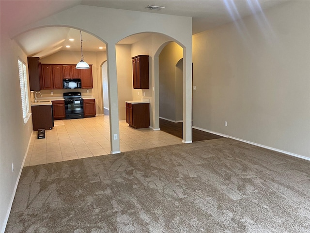 kitchen with decorative light fixtures, light colored carpet, lofted ceiling, black appliances, and sink