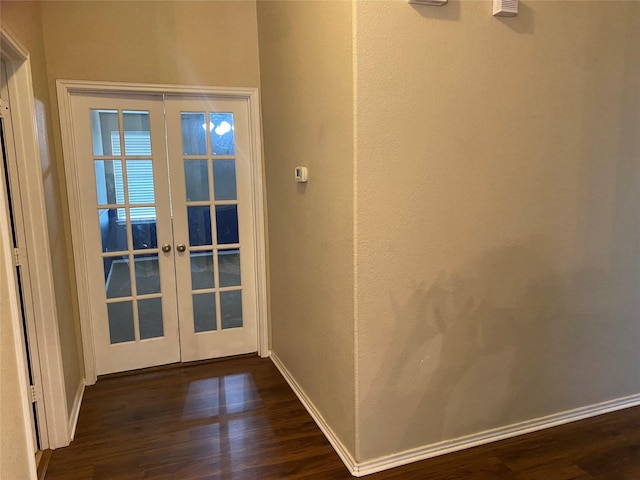 entryway with dark hardwood / wood-style floors and french doors