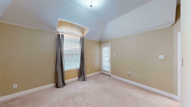 spare room with light carpet, crown molding, and lofted ceiling