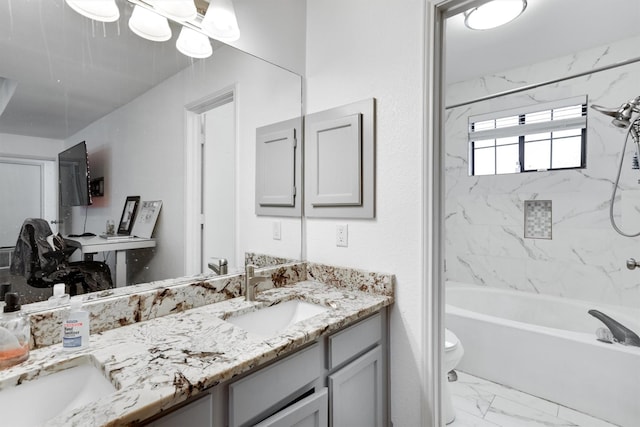 full bathroom featuring toilet, vanity, and tiled shower / bath