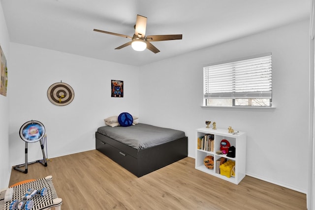 bedroom with ceiling fan and wood-type flooring