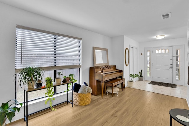 entryway with plenty of natural light and light hardwood / wood-style flooring