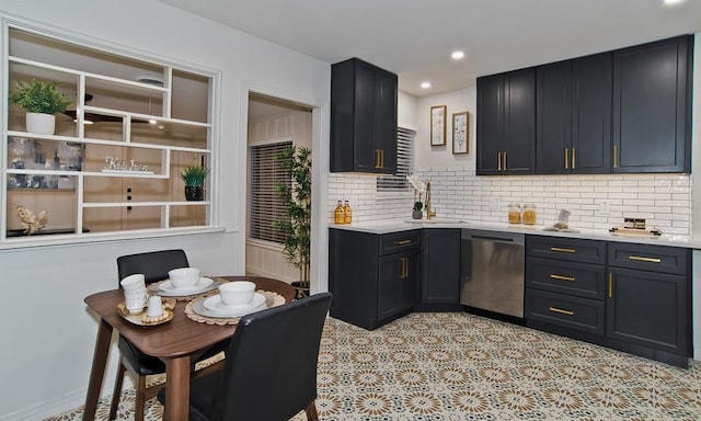 kitchen featuring sink, decorative backsplash, and stainless steel dishwasher