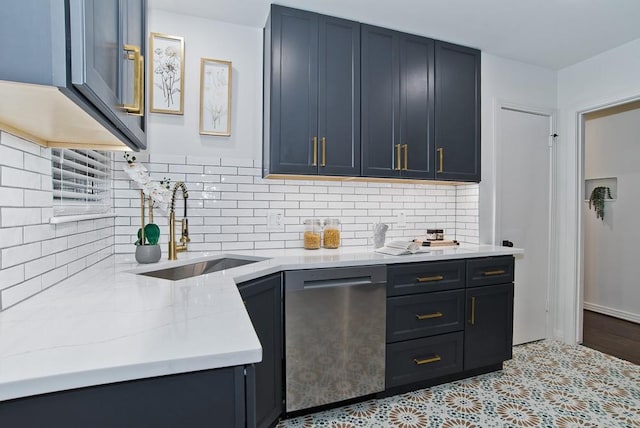 kitchen featuring tasteful backsplash, sink, light stone counters, light tile patterned floors, and stainless steel dishwasher