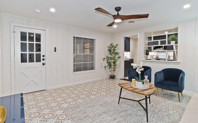 living area with ceiling fan